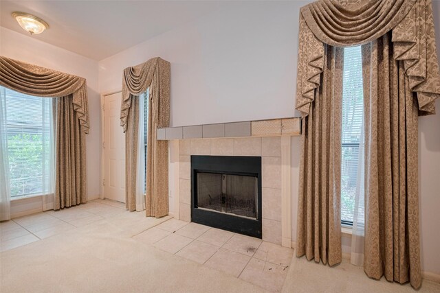 interior details featuring a tiled fireplace