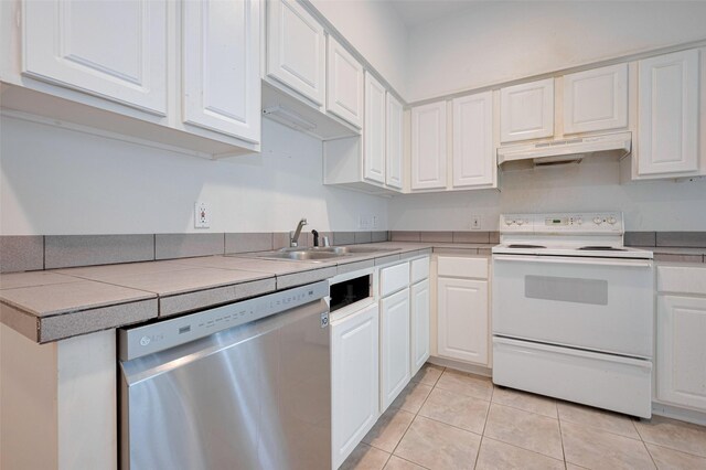 kitchen featuring white cabinets, white electric range oven, a sink, dishwasher, and under cabinet range hood