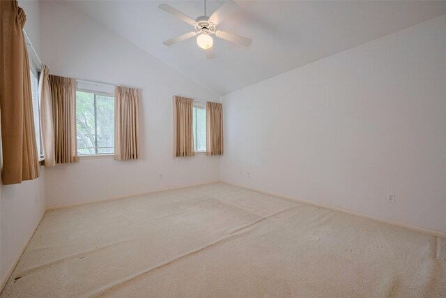 carpeted spare room featuring baseboards, ceiling fan, and lofted ceiling