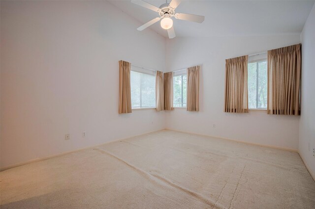 unfurnished room featuring baseboards, ceiling fan, carpet flooring, and high vaulted ceiling