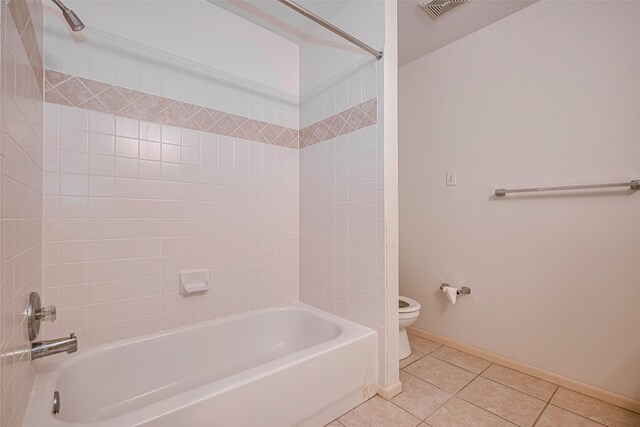 full bath featuring tile patterned flooring, visible vents, toilet, baseboards, and shower / washtub combination