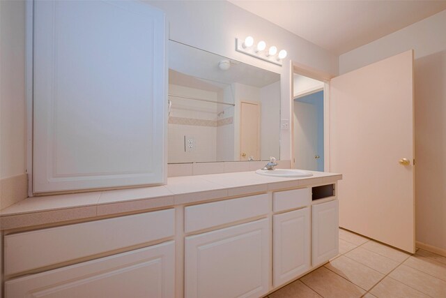 full bathroom featuring walk in shower, tile patterned floors, and vanity