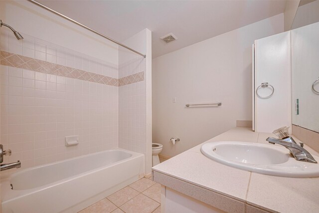 bathroom featuring vanity, toilet, tile patterned floors, shower / washtub combination, and visible vents