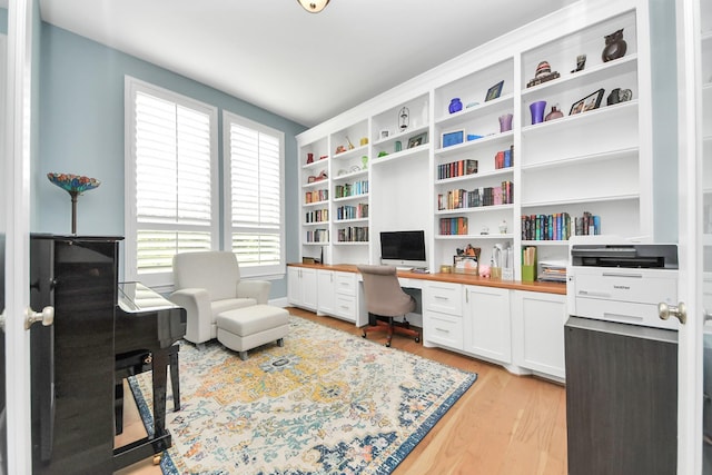 office area featuring built in study area and light wood finished floors
