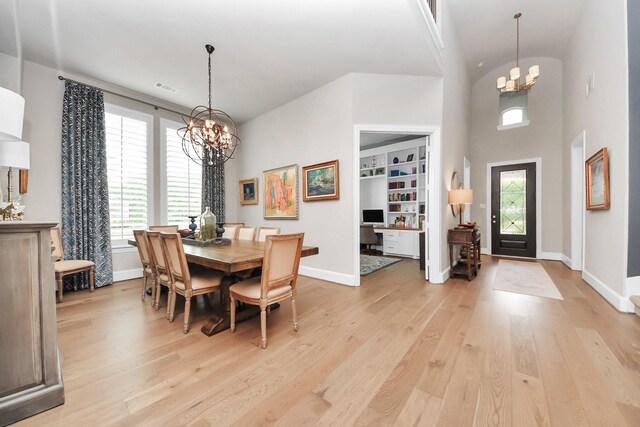 dining room with baseboards, a notable chandelier, visible vents, and light wood-style floors