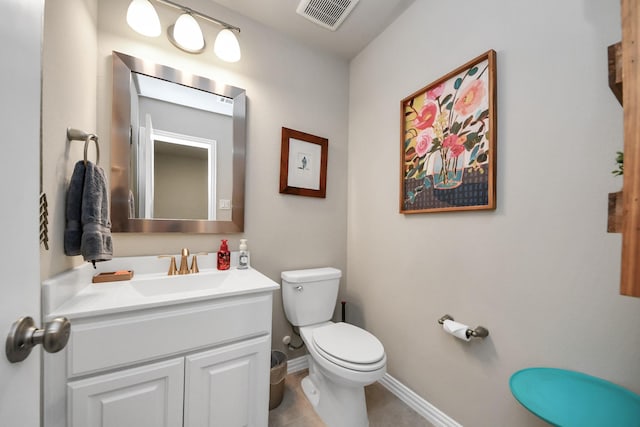 half bath featuring visible vents, vanity, baseboards, tile patterned floors, and toilet