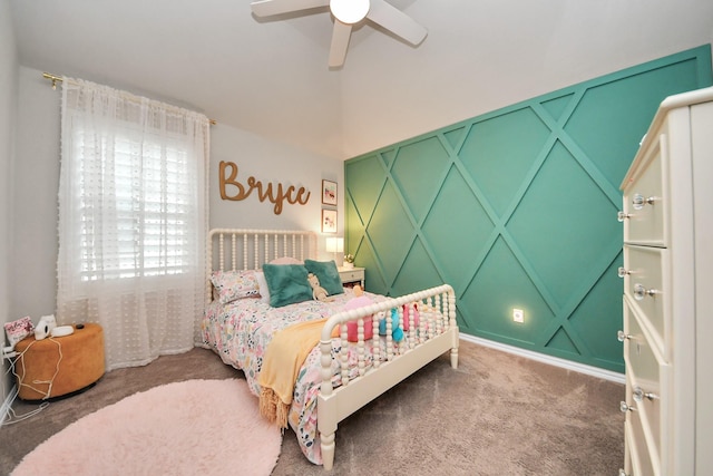 bedroom with carpet floors, ceiling fan, and a decorative wall