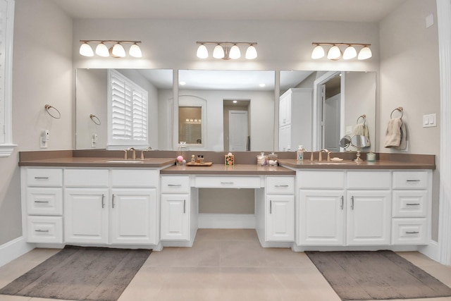 full bathroom featuring baseboards, tile patterned floors, and vanity
