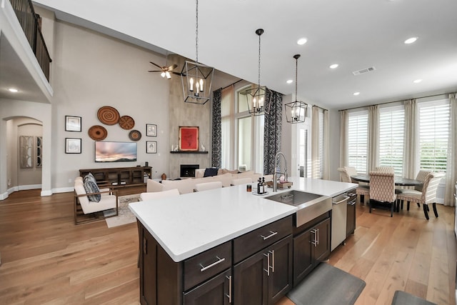 kitchen with visible vents, a sink, light wood-style floors, and stainless steel dishwasher