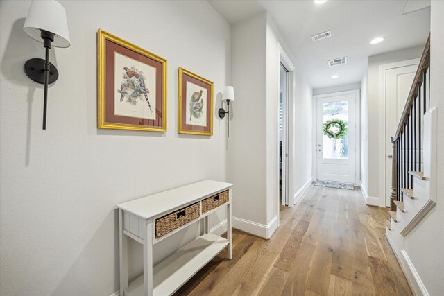 2421 W Kolbe Ln, Houston, TX 77080 - hallway featuring visible vents, baseboards, wood finished floors, and stairway
