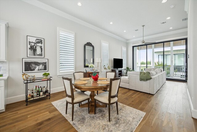 2421 W Kolbe Ln, Houston, TX 77080 - dining space featuring crown molding, a healthy amount of sunlight, wood finished floors, and visible vents
