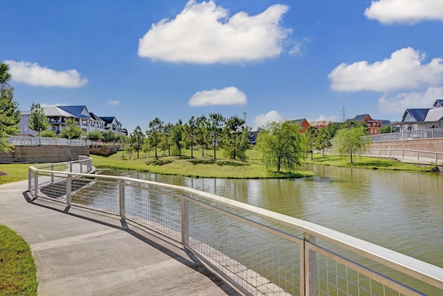 dock area with a residential view and a water view
