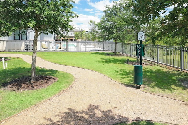 surrounding community featuring a lawn and fence