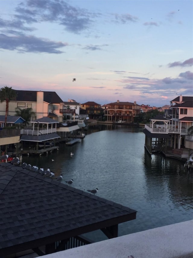 dock area with a residential view and a water view