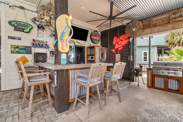 bar featuring a ceiling fan and a dry bar