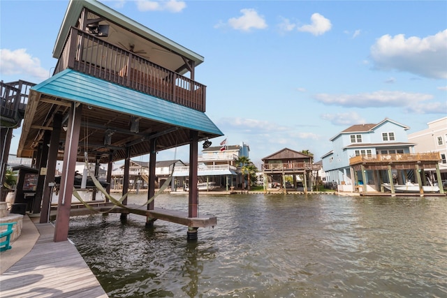 dock area featuring boat lift and a water view