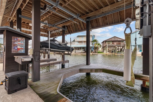 dock area with boat lift and a water view