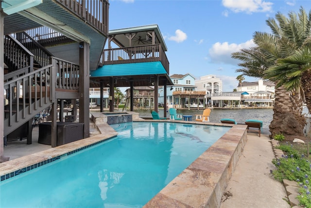 view of swimming pool featuring a patio, ceiling fan, a pool with connected hot tub, and stairs