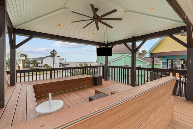 wooden terrace with a residential view and ceiling fan