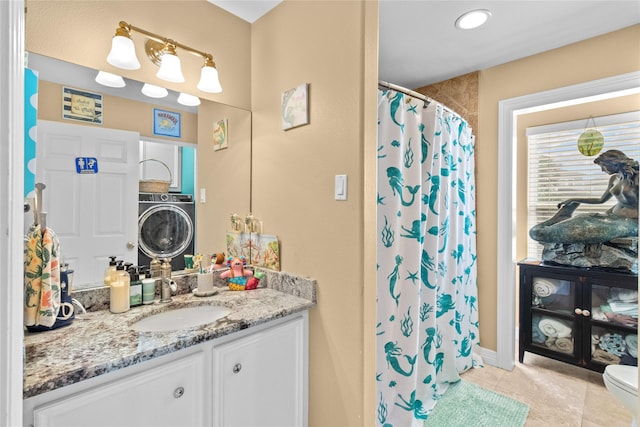 bathroom featuring vanity, toilet, tile patterned floors, washer / clothes dryer, and curtained shower