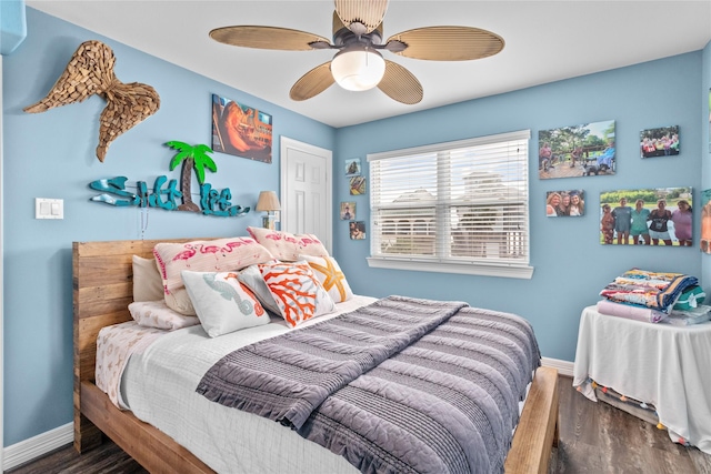 bedroom featuring a closet, baseboards, a ceiling fan, and wood finished floors