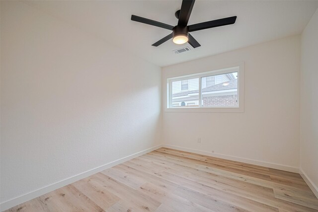 spare room with a ceiling fan, baseboards, visible vents, and light wood-style floors