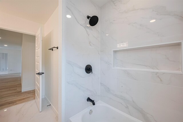 full bath with baseboards, marble finish floor, and tub / shower combination