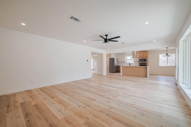 unfurnished living room with recessed lighting, baseboards, visible vents, and light wood-style floors