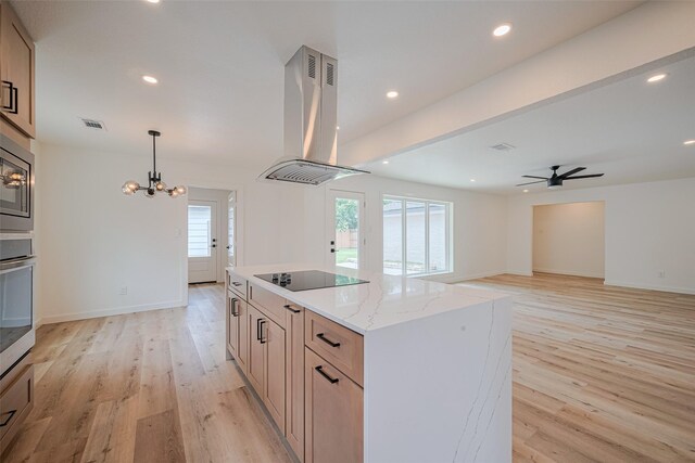 kitchen featuring light wood-type flooring, appliances with stainless steel finishes, ceiling fan with notable chandelier, and island range hood