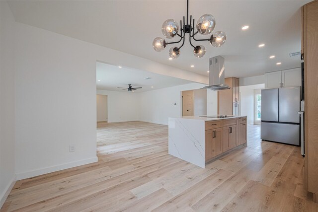 kitchen with freestanding refrigerator, black electric stovetop, island range hood, recessed lighting, and light wood-style flooring