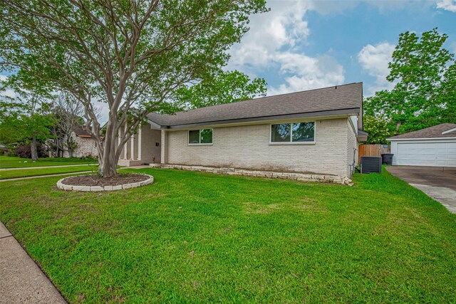single story home with brick siding, central AC unit, a front yard, and a garage