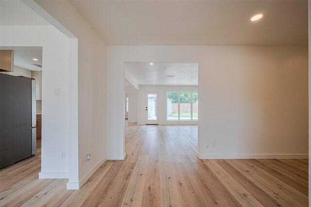 hallway with recessed lighting, baseboards, and light wood finished floors