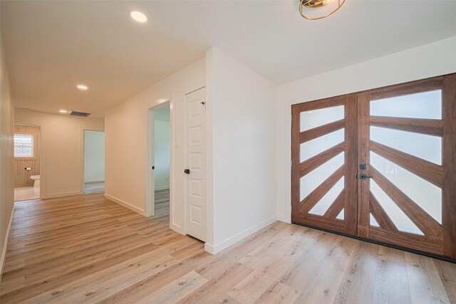foyer entrance with visible vents, recessed lighting, light wood-style floors, and baseboards
