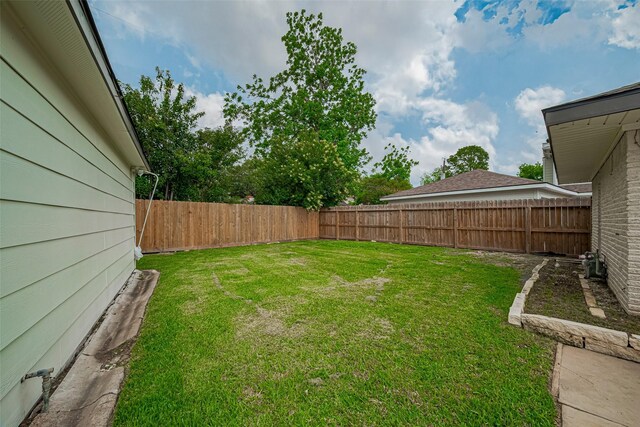 view of yard with a fenced backyard