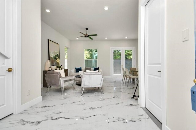 living area featuring recessed lighting, ceiling fan, baseboards, and marble finish floor