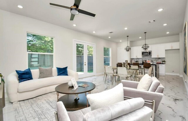 living area featuring visible vents, recessed lighting, and marble finish floor
