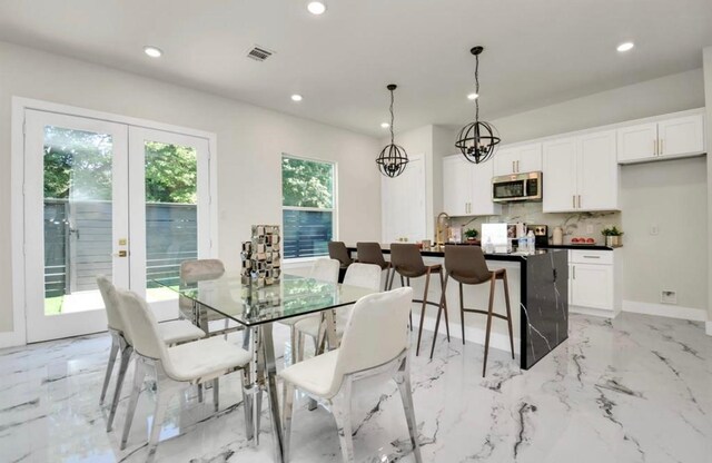 dining room featuring visible vents, recessed lighting, marble finish floor, and french doors