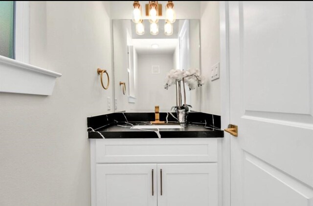 bathroom featuring vanity and a notable chandelier