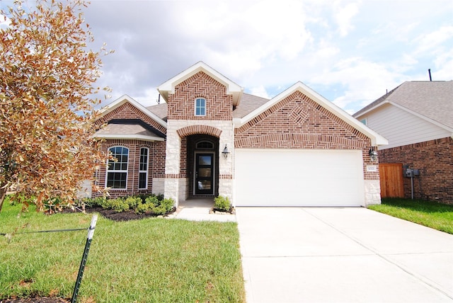 view of front of house featuring a garage, a front lawn, roof with shingles, brick siding, and concrete driveway
