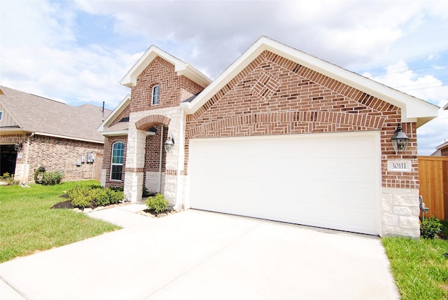 view of front facade featuring a garage, driveway, a front lawn, and brick siding