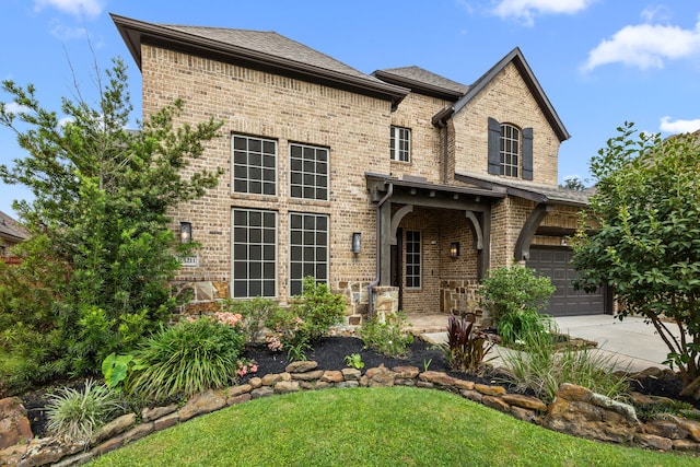 25211 Birchwood Springs Ave, Porter, TX 77365 - view of front of home featuring brick siding, an attached garage, a front yard, and concrete driveway