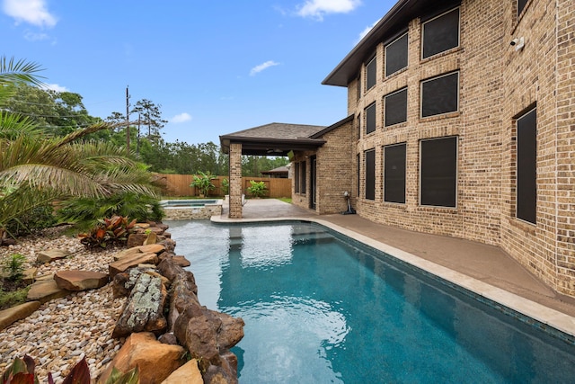 25211 Birchwood Springs Ave, Porter, TX 77365 - view of pool with a fenced in pool, an in ground hot tub, a patio area, and a fenced backyard