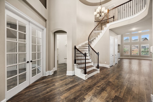 25211 Birchwood Springs Ave, Porter, TX 77365 - entrance foyer featuring baseboards, french doors, dark wood-style floors, and a towering ceiling