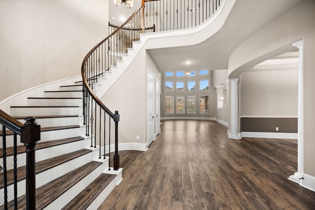 25211 Birchwood Springs Ave, Porter, TX 77365 - foyer entrance with decorative columns, a towering ceiling, wood finished floors, baseboards, and stairs