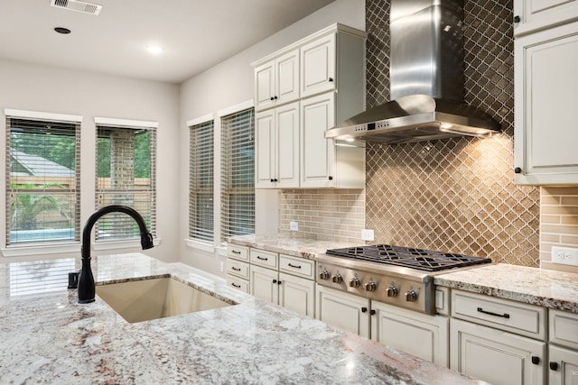 25211 Birchwood Springs Ave, Porter, TX 77365 - kitchen featuring a sink, decorative backsplash, wall chimney range hood, and stainless steel gas stovetop
