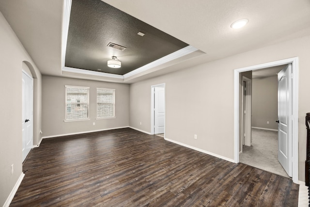 25211 Birchwood Springs Ave, Porter, TX 77365 - unfurnished bedroom featuring a raised ceiling, baseboards, dark wood-type flooring, and visible vents