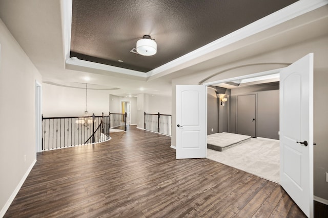 25211 Birchwood Springs Ave, Porter, TX 77365 - hallway with a raised ceiling, wood finished floors, and a notable chandelier