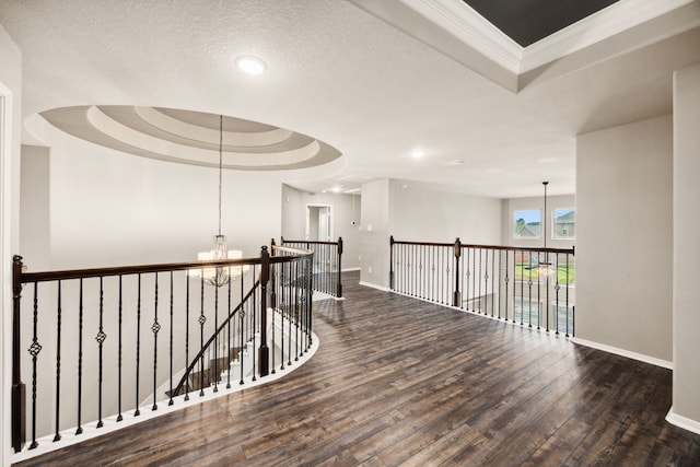 25211 Birchwood Springs Ave, Porter, TX 77365 - hallway featuring baseboards, a tray ceiling, an inviting chandelier, and wood finished floors
