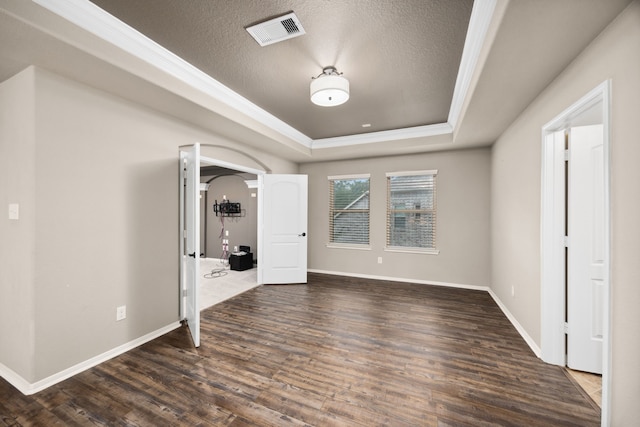 25211 Birchwood Springs Ave, Porter, TX 77365 - unfurnished bedroom with crown molding, a raised ceiling, arched walkways, wood finished floors, and visible vents