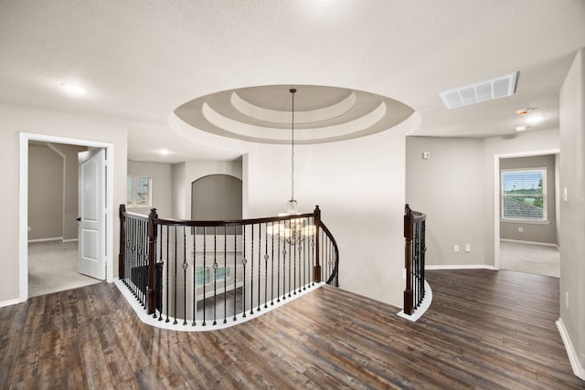 25211 Birchwood Springs Ave, Porter, TX 77365 - hallway with baseboards, visible vents, wood finished floors, and an upstairs landing